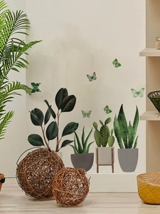 Detail of hand-painted potted plant wall stickers and green butterflies for home decor