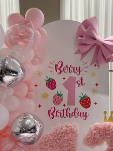 Close-up of Berry 1st Birthday strawberry themed arch backdrop for party decoration