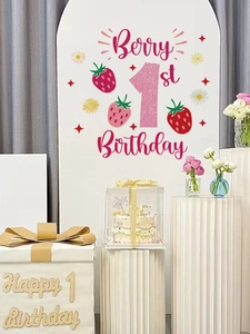 Detail of pink glitter number 1 and strawberry decals on party backdrop