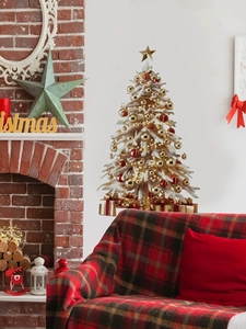 Detail of gold Christmas tree wall sticker with red ornaments on a cozy living room wall