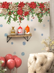 Detail of Christmas wall stickers with red poinsettias, green leaves and blue snowflakes