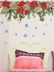 Detail of Christmas wall stickers featuring poinsettias, red berries, and blue snowflakes