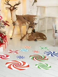 Detail showing colorful Christmas candy swirl floor decals in a festive indoor setting