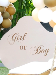 Detail of Girl or Boy decal on arched backdrop for gender reveal party decoration
