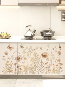 Detail of vintage wildflower and butterfly PVC wall stickers on a modern kitchen cabinet