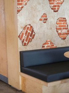 Detail of 3D self-adhesive PVC wall sticker showing red brick texture behind wood panels