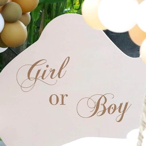 Gender reveal party decoration board with Boy or Girl lettering and balloons