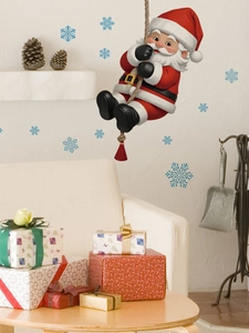 Detail of Santa Claus climbing rope wall decal with blue snowflakes in a cozy living room