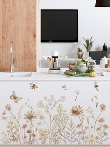 Close-up of Bohemian wildflower wall decals on a modern kitchen island with butterflies
