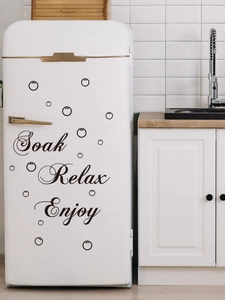 Detail view of Soak Relax Enjoy black wall stickers and bubbles on a white fridge surface