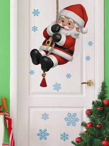 Detail of Santa Claus climbing rope wall sticker with blue snowflakes on a white door
