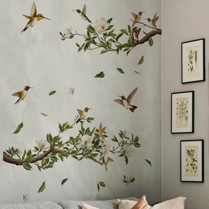 Green branches with white magnolia flowers and colorful hummingbirds wall decals