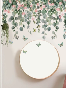 Detail of DIY floral wall stickers with butterflies and eucalyptus leaves on white walls