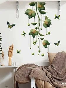 Close-up of green hanging plants and butterflies wall stickers in a cozy home setup