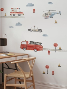 Detail view of watercolor rescue vehicle wall stickers in a cozy nursery room setting