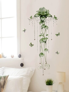 Detail view of green flower wall sticker with butterflies and beads in bedroom decor