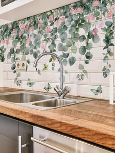 Detail of waterproof PVC wall stickers with eucalyptus leaves and pink roses in a kitchen