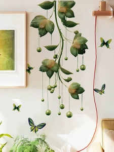 Detail of green floral vine wall stickers with hanging beads and colorful butterflies