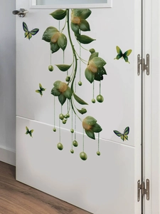 Detail of green vine wall stickers with orange flowers and butterflies on white door