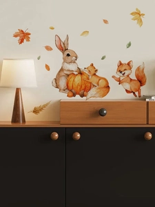 Detail of hand-painted rabbit, fox, and pumpkin wall stickers in a cozy autumn theme