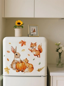Watercolor rabbit and fox wall stickers with autumn pumpkins on a white fridge surface