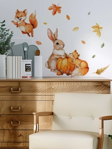 Detail of watercolor fox and rabbit wall decals on a cozy living room wall