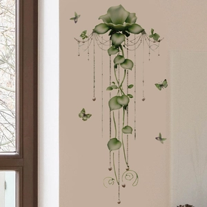Elegant green flower wall sticker with butterflies and pearl chains on a beige wall