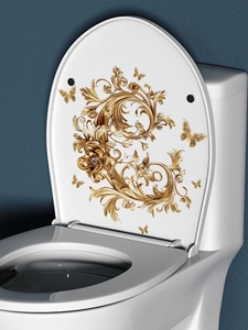 Close-up of golden Baroque vine pattern and butterflies on decorative toilet lid decal