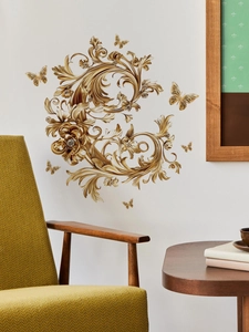 Detailed view of golden baroque wall decals with flower and butterfly patterns in a living room