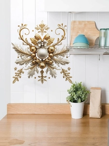 Detail of golden snowflake wall sticker with scroll patterns on a white tile wall