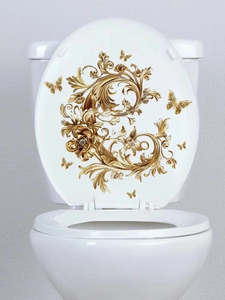 Detail of golden baroque floral butterfly wall stickers on a white toilet lid cover