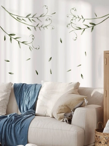 Detailed watercolor green leaf vine wall stickers in a cozy living room setting