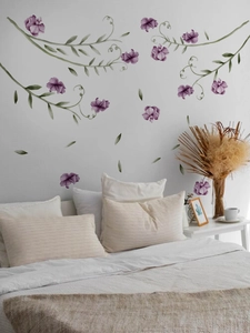 Detailed wall sticker featuring purple flowers and green vines in a cozy bedroom setting