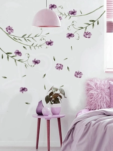 Detailed watercolor purple flowers and green vines wall sticker in a cozy bedroom