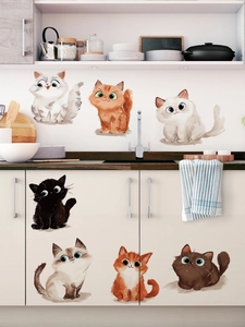 Detail of seven cute hand-drawn cartoon cat wall stickers on a modern kitchen cabinet