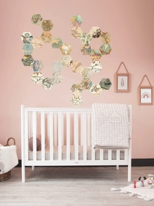 Close-up of hexagonal vintage world map wall stickers in a cozy nursery room setting