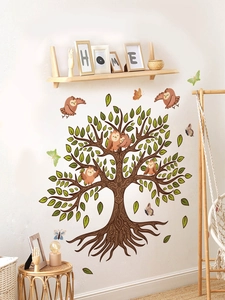 Detail of owl and tree branch wall decals in a warm and cozy home interior setting