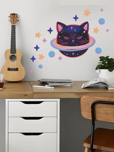 Cosmic cat and planet wall decal set displayed in a creative home office setting