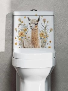 Detail of alpaca and yellow rose vinyl wall decal applied to a white ceramic toilet tank