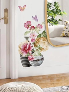 Detail of floral wall decals featuring flower vases and butterflies on a white wall