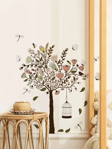Detailed view of hand-painted floral tree wall decal with birdcages and butterflies