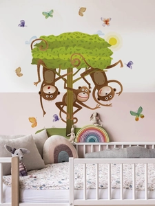 Detailed wall sticker layout featuring cartoon monkeys and a tree in a cozy nursery setting