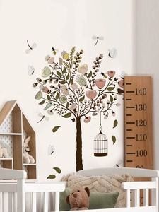 Close-up of birdcage tree wall decal with flowers and butterflies in a nursery setting