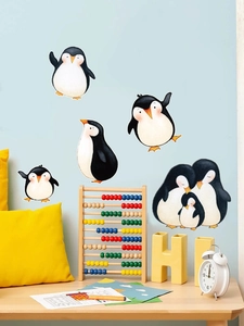 Charming penguin family wall decals on a light blue background for nursery room decor