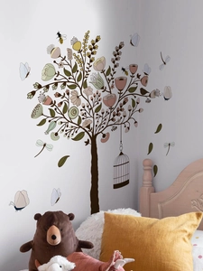 Detail of tree wall sticker with birdcage and flowers in a cozy bedroom scene