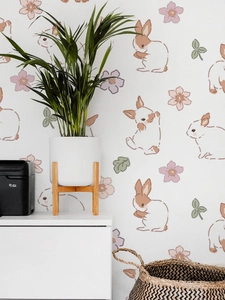 Detail showing hand-painted rabbit and flower wall decals in a cozy interior setting