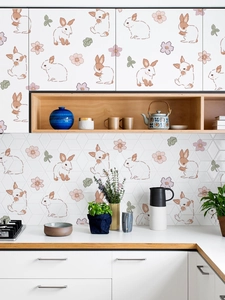 Detail view of rabbit and flower wall decals applied to a kitchen cabinet and backsplash