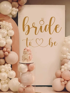 Elegant gold Bride to Be wall decal with ring and heart accents for bridal shower decor