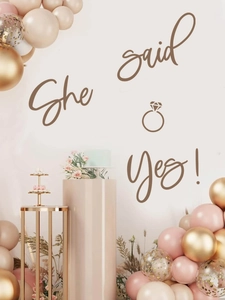 Close-up of engagement party set with She said Yes wall decal and assorted balloons