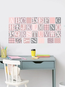 Close-up of pink and grey patterned alphabet wall stickers in a cozy study room setting